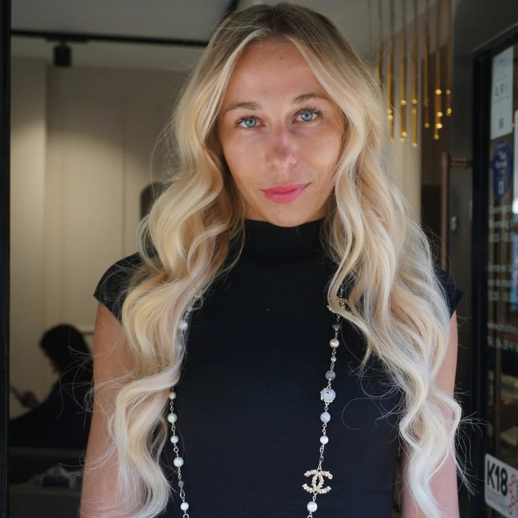 Creamy blonde long hair extensions at BRUSH Amsterdam hair salon.